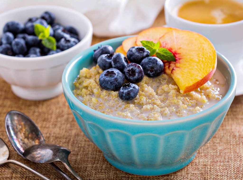 Peach blueberry and banana custard porridge with pepitas and quinoa
